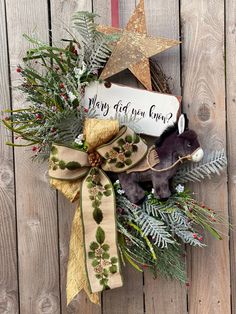 a wreath with a teddy bear and christmas decorations