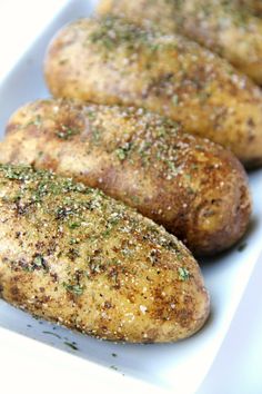 three pieces of baked potatoes with seasoning on them