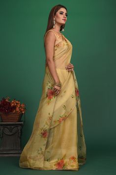 A very unique saree with Handloom Cotton Silk fabric till the pleats and Chanderi fabric with Bronze motifs which is translucent in the front. It also has a Pallu with bronze weave and fringes which makes the whole saree really exquisite. The entire saree has a Golden border. Enhance with a beautiful floral pattern, the vintage design enhances the royal look of the saree. Made with an intricate technique, this is a heritage of its own kind. With a rich border enveloping the saree, it is a stella Gold Floor-length Tissue Silk Saree, Pre-draped Organza Saree With Zari Weaving, Organza Pre-draped Saree With Zari Weaving, Floor-length Tissue Silk Pre-draped Saree With Sheer Dupatta, Gold Chanderi Floor-length Saree, Chanderi Pre-draped Saree With Pallu, Organza Saree With Zari Weaving In Traditional Drape, Chanderi Pre-draped Saree With Pallu And Floor-length, Floor-length Chanderi Pre-draped Saree With Pallu