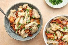 two bowls filled with food on top of a table