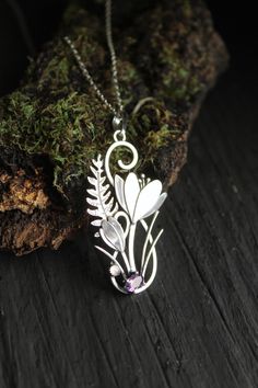 ITEM DESCRIPTION: The size H 5 cm x W 3 cm (2 x 1 inch). Weight - 4 g. You can buy it with a silver chain or without it. I made this unique Crocus pendant of sterling silver, dark amethyst, and moonstone. This is similar to the first spring flowers that appear from under the snow. The floral necklace looks so gentle and elegant! This handmade necklace will come to you in a gift box - ready for gifting. The parcel will be sent 1-2 days after payment. Delivery usually takes 10-21 days. But in the Silver Nature-inspired Necklace With Flower Charm, Silver Necklace With Nature-inspired Flower Charm, Nature-inspired Flower Charm Pendant Necklace, Nature-inspired Silver Flower Necklace With Charm, Nature-inspired Flower Shaped Sterling Silver Jewelry, Nature-inspired Sterling Silver Flower Jewelry, Purple Flower Shaped Jewelry For Spring, Silver Flower Pendant Necklace For Mother's Day, Silver Birth Flower Pendant Jewelry