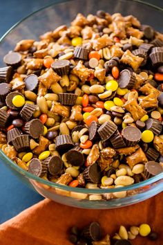 a glass bowl filled with candy corn and chocolate