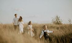 a group of people that are standing in the grass