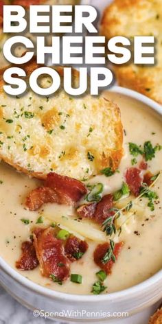 beer cheese soup in a white bowl with bread on the side