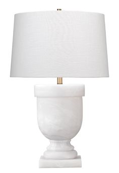 a white table lamp with a gold base and a white linen shade on the top