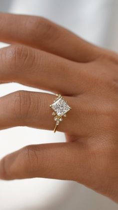 a woman's hand with a diamond ring on it