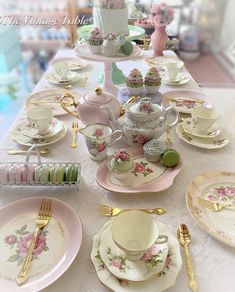 the table is set with pink and white china