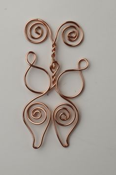 a piece of copper wire with swirls on it