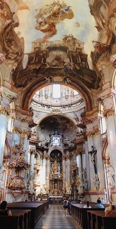 the inside of a church with people standing in it