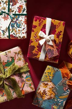 four wrapped presents with bows on them