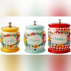 three ceramic jars with flowers painted on them