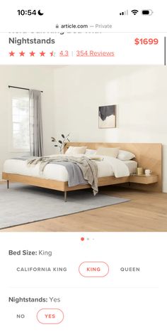 a bed sitting on top of a wooden floor next to a white wall and window