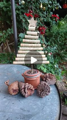 a small christmas tree made out of wine corks on a table in the garden