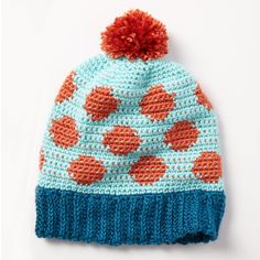 a blue and orange knitted hat with hearts on it