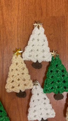 small crocheted christmas trees on a wooden surface