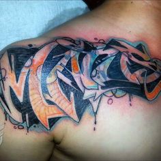 a man's chest with an abstract tattoo design on the upper part of his arm