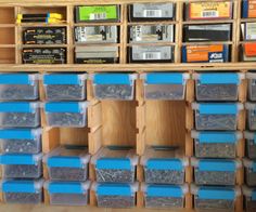 the shelves are filled with many different types of screws and other things in plastic containers