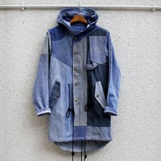 a blue jacket hanging on a white wall