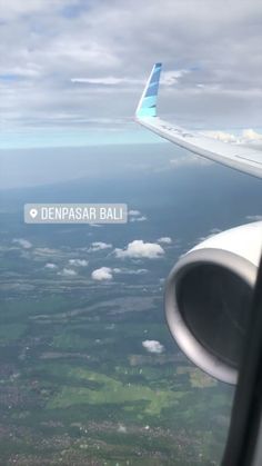 an airplane wing with the words denpasr bali on it's left side