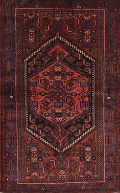 an antique persian rug with red and blue designs on the center, surrounded by smaller geometric shapes