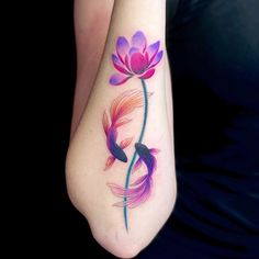 a woman's foot with a watercolor painting style flower and fish on it