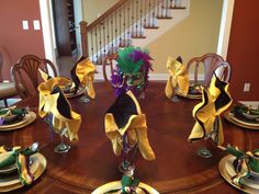 the table is set with yellow and black napkins