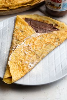 two tortillas on a plate with chocolate spread