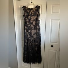 a black dress hanging on a white door