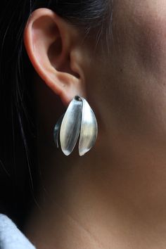 The inspiration for these elegant silver stud earrings come from the shape of the fragrant cananga flower, commonly called Ylang-ylang in English. They are entirely handmade from 95% silver and are very lightweight and comfortable to wear. The surface was etched with the so-called cat-fur technique, typically used by Thai Karen silversmiths. Our products are hand crafted in 95-98% Silver by Thai Karen hill-tribe artisans. The Karen are a group of ethnic peoples who reside primarily in southern a Flower Handmade, Silver Earrings Handmade, Silver Bead Bracelet, Satin Color, Silver Stud Earrings, Silver Earring, Ylang Ylang, Silver Earrings Studs, Silver Studs