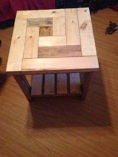 a small wooden table sitting on top of a hard wood floor