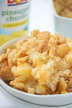 a white bowl filled with food next to a bottle of pineapple churros