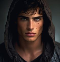 a young man with freckles on his face and hoodie over his head