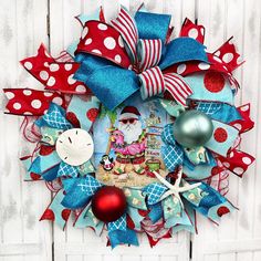 a christmas wreath with red, white and blue decorations