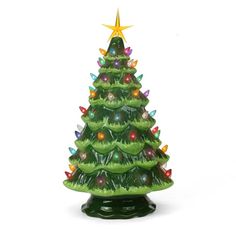 a green ceramic christmas tree with lights on it's sides and a star above the top