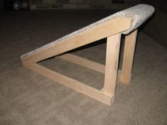 a wooden bench sitting on top of a carpeted floor