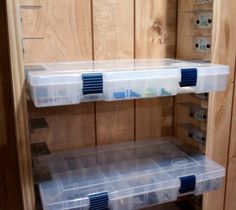 two plastic storage bins are on the shelves