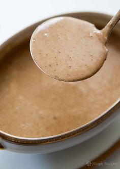 a spoon full of peanut butter on top of a pot