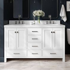 a white bathroom vanity with two sinks and mirrors on the wall next to a toilet