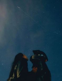 a man and woman standing under a blue sky