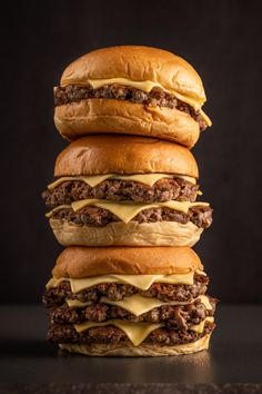 three cheeseburgers stacked on top of each other