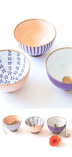 four bowls with different designs and colors on them