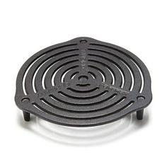 a cast iron stove grate sitting on top of a white surface