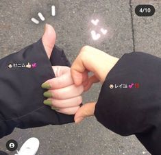 two people are holding hands with stickers on their fingers and pointing to each other