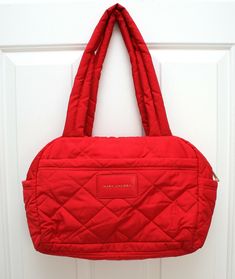 MARC JACOBS Quilted Nylon Small Weekender Bag Duffle Bag Travel Bag RED  Bought new and never used, comes without tag Style No. M0017015 Retails new for $275.00 Great bag for travel or everyday wear, also packable  Color is pretty red in quilted nylon  Top handle with 11" drop & detachable crossbody/shoulder strap in red, black, white canvas stripe with 30" strap drop  Shiny gold tone hardware Exterior has 2 side slip pockets & 1 front zipper compartment Small size bag measures 13" length across Red Quilted Travel Shoulder Bag, Red Quilted Shoulder Bag For Travel, Red Nylon Shopping Bag, Red Quilted Travel Bag, Black White Canvas, Red Tote Bag, Bag For Travel, Red Tote, Duffle Bag Travel