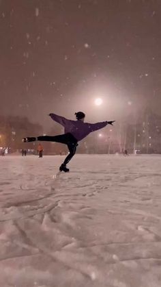 a person doing a trick on a snowboard in the middle of a snowy field