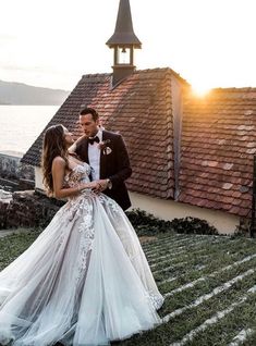 a man in a tuxedo standing next to a woman in a wedding dress