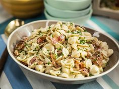 a bowl filled with pasta and meat on top of a table