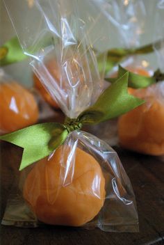 small oranges wrapped in plastic and sitting on a table