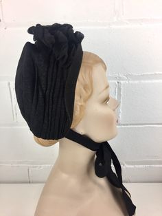 Antique Victorian Black Bonnet Cap With Bow & Ribbon Ties, Black Crepe, Net Veil Lining, Victorian Mourning, Civil War Clothing COLOR: Black. MATERIAL: Crepe, net, ribbon. Wire. CONDITION: The ribbon ties have a hole on one side and wear along fold lines. Slight fade on the bottom left corner (near chin). Net lining has come undone from inside along bottom, has been pinned. The exterior is in excellent condition. MEASUREMENTS: Inner diameter: approx. 8 in. (20.3 cm) Crown Height: 4 in. (10 c Elegant Black Adjustable Bonnet, Elegant Adjustable Black Bonnet, Fitted Costume Bonnet, Vintage Fitted Bonnet For Costume, Black Bonnet, Net Veil, Widow's Peak, Bonnet Cap, Crown Heights