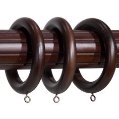 the curtain rod is made from wood and has three rings on each end, one with two